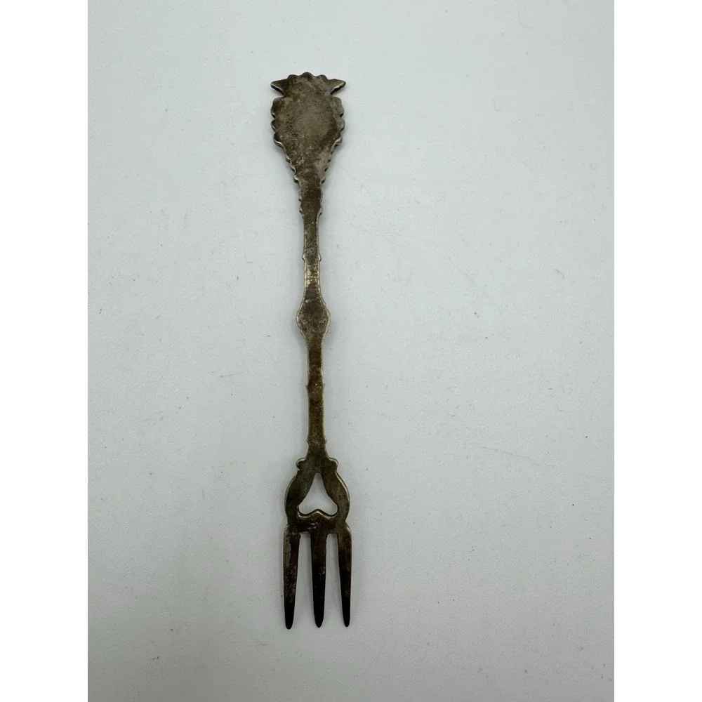 Ornate Italian souvenir fork with a lion rampant and crown motif